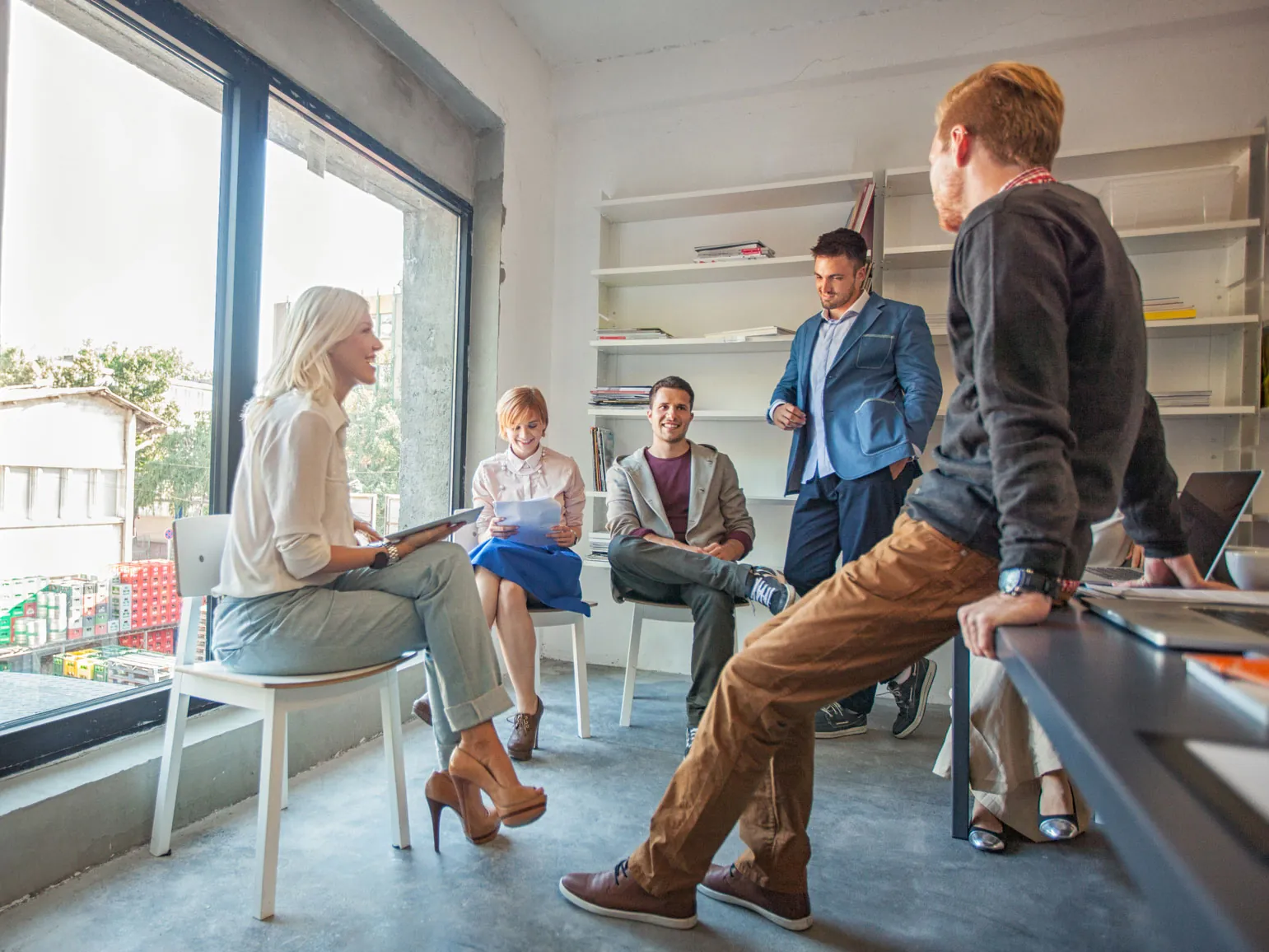 Remote offices - group of employees sitting in a circle and having a discussion