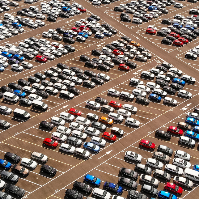 Many Cars Parked Outside in Parking Lot
