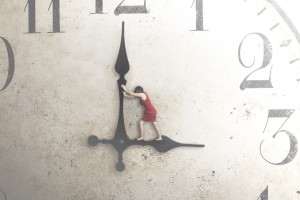 Person standing on the hands of a clock trying to stop time