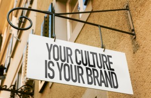 Sign on the side of a building that says: Your Culture Is Your Brand