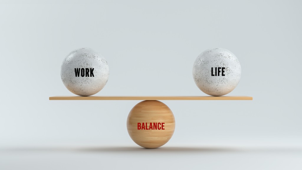 Spheres forming scale with the words work life and balance