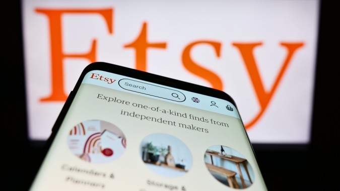 Employee trust - screenshot of smartphone showing Etsy homescreen with backdrop of computer screen showing Etsy graphic
