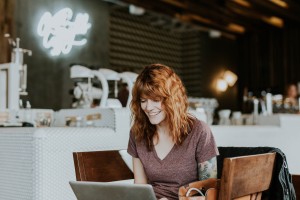 women using laptop and smiling