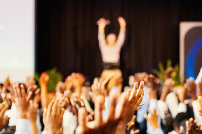 Intranet benefits - crowd of people with their hands in the air at a concert 
