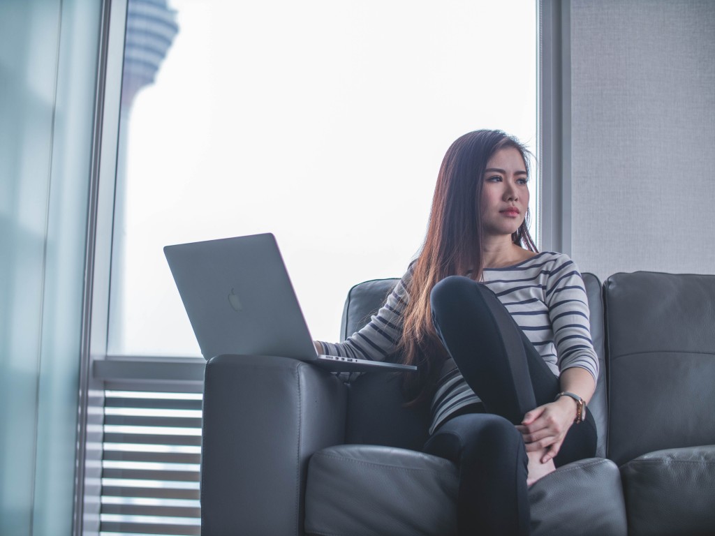 Why intranets fail - female employee looking away from laptop with disinterested look on her face