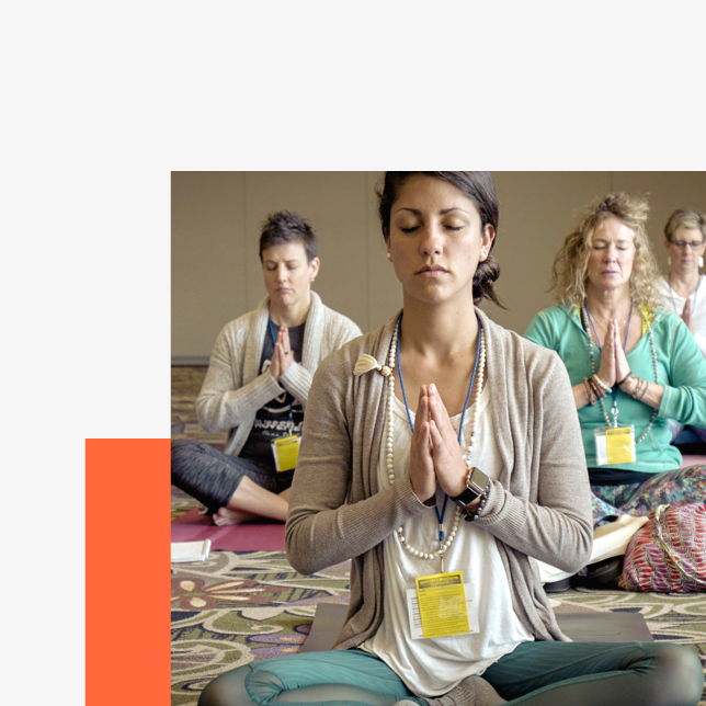 Employee meditating in front of their laptop as part of an employee well-being program