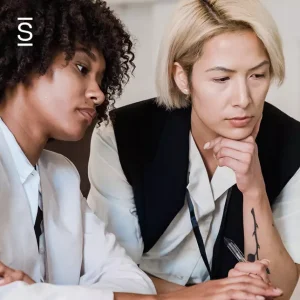 Eliminate tech debt - two women collaborating and working on a computer