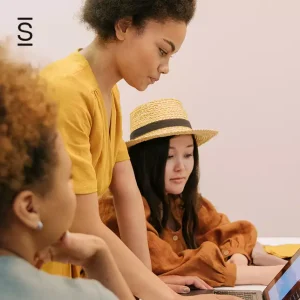 Internal communications technology - three female employees in a meeting looking at a laptop