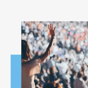 Organizational culture - woman in crowd holding up her hand