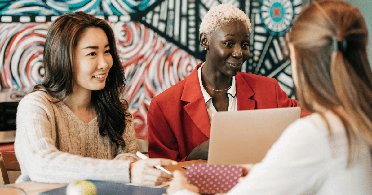 IC, HR and IT professionals reviewing insights on a laptop to determine the best intranet from Simpplr's 2026 buyer's guide.