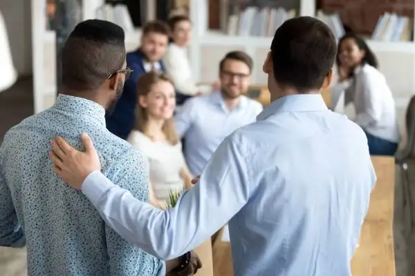 Employee onboarding - diverse workplace. New employee having first working day in company standing in front of colleagues, executive manager employer introducing welcoming newcomer to workmates. Human resources employment concept