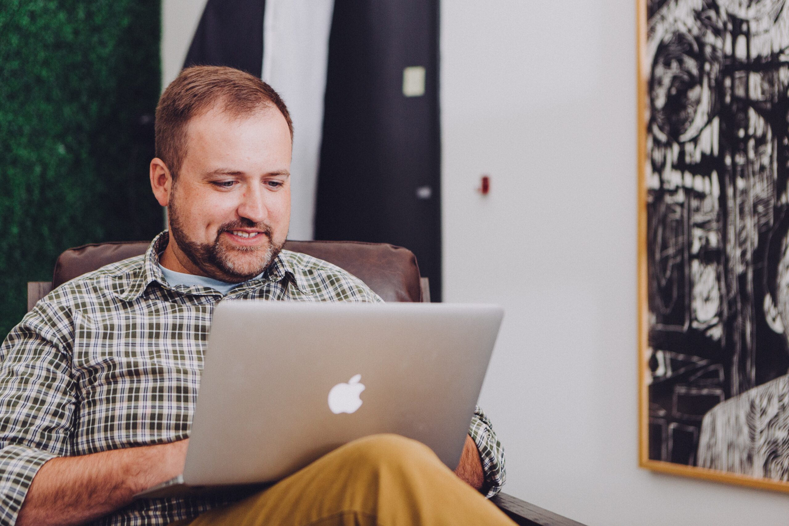 An individual working on a laptop, using an employee performance management system to track goals, monitor progress, and boost productivity.