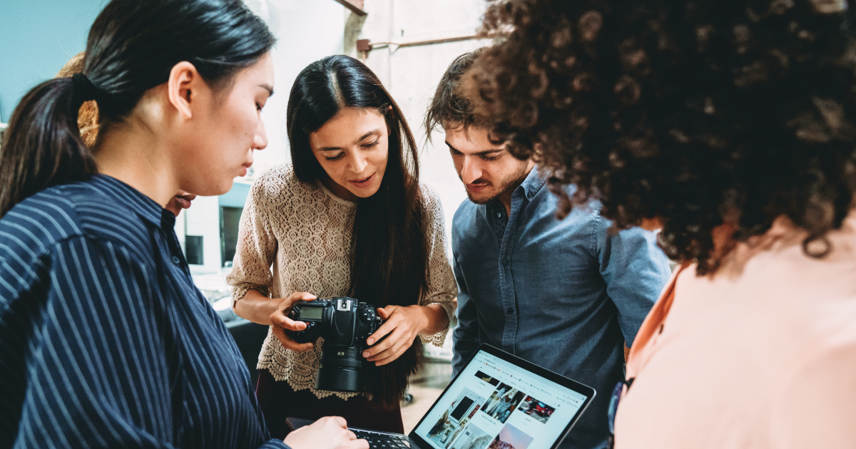 Employees collaborating to create videos and branded visuals in a creative workspace