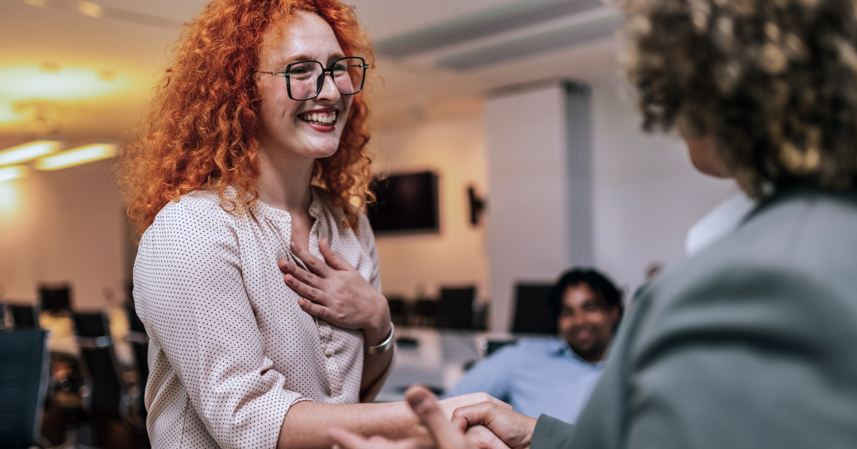 Employees being recognized and appreciated in a workplace setting.