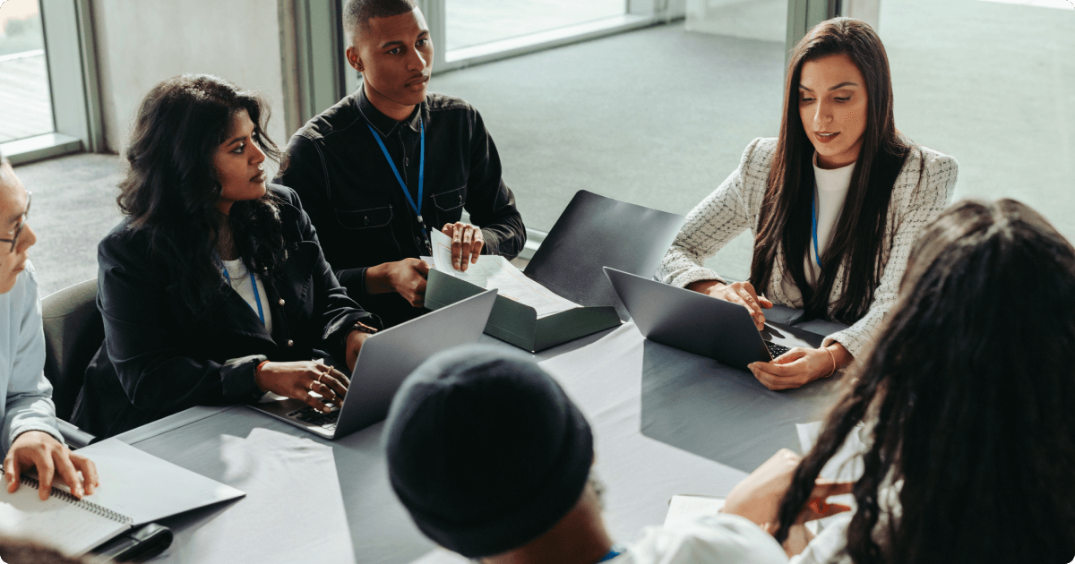 Team of employees collaborating on a project, representing strong corporate culture and teamwork.