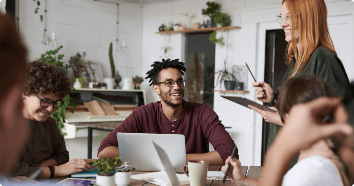 Happy productive employees collaborating in modern workplace