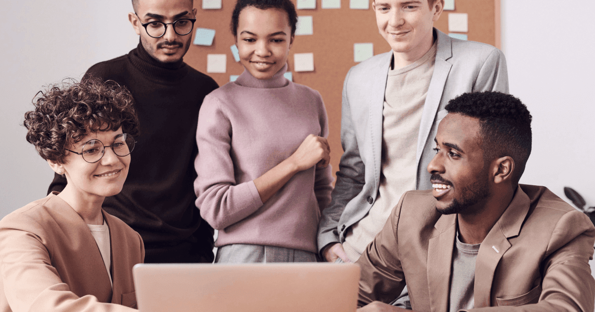 Happy employees at work after a positive employee experience survey.
