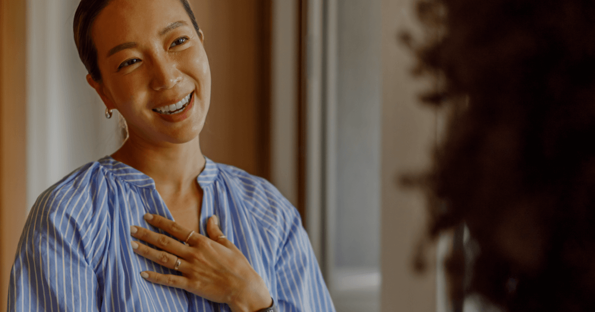 Happy employees at work, smiling together after receiving appreciation.