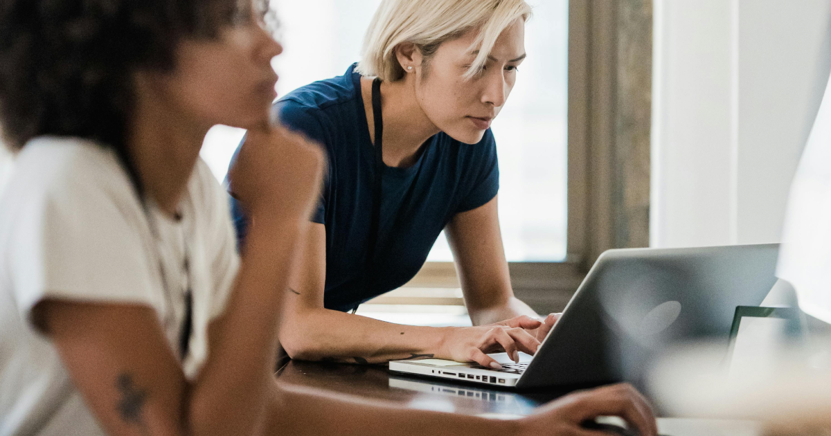 IC professional busy using Gen AI for internal communication on her laptop, reviewing messages and campaign plans.